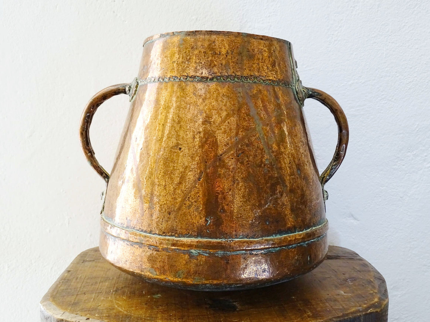 Tapered French antique copper vessel twin handles and a rounded base. Antique copper pot for French countryside decor.