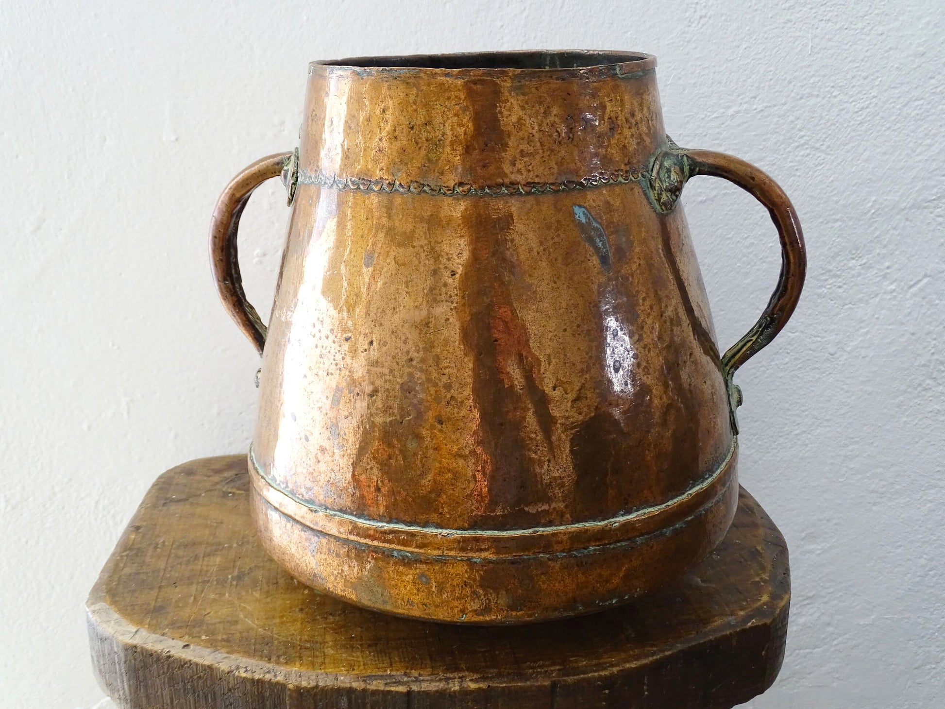 Tapered French antique copper vessel twin handles and a rounded base. Antique copper pot for French countryside decor.