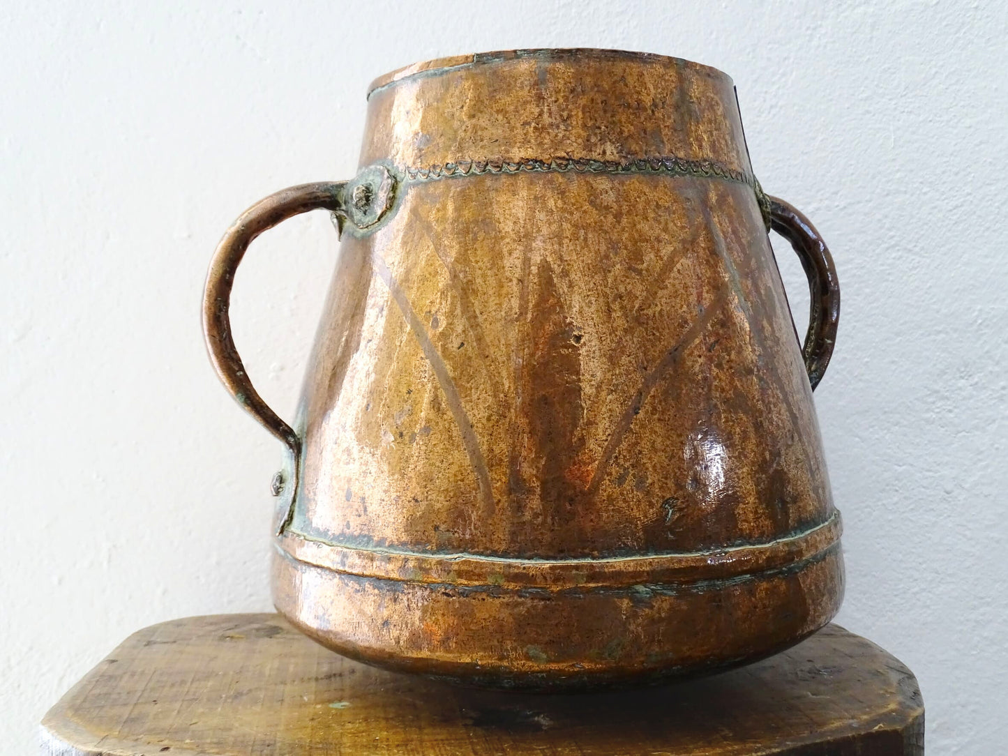 Tapered French antique copper vessel twin handles and a rounded base. Antique copper pot for French countryside decor.