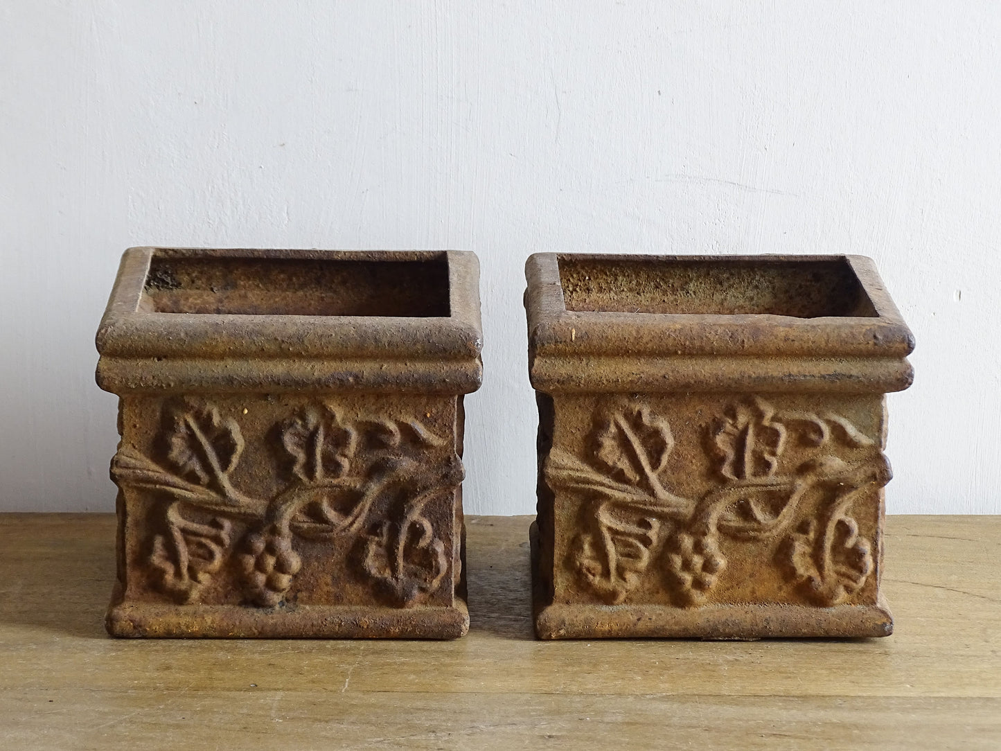 Pair of French antique cast iron planters. Square plant pots with grape and vine decoration. Indoor or outdoor decor. 