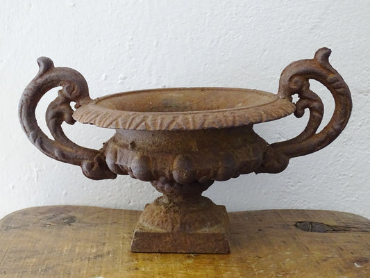 Antique French Medici cast iron urn planter or jardiniere with handles and rusted patina.