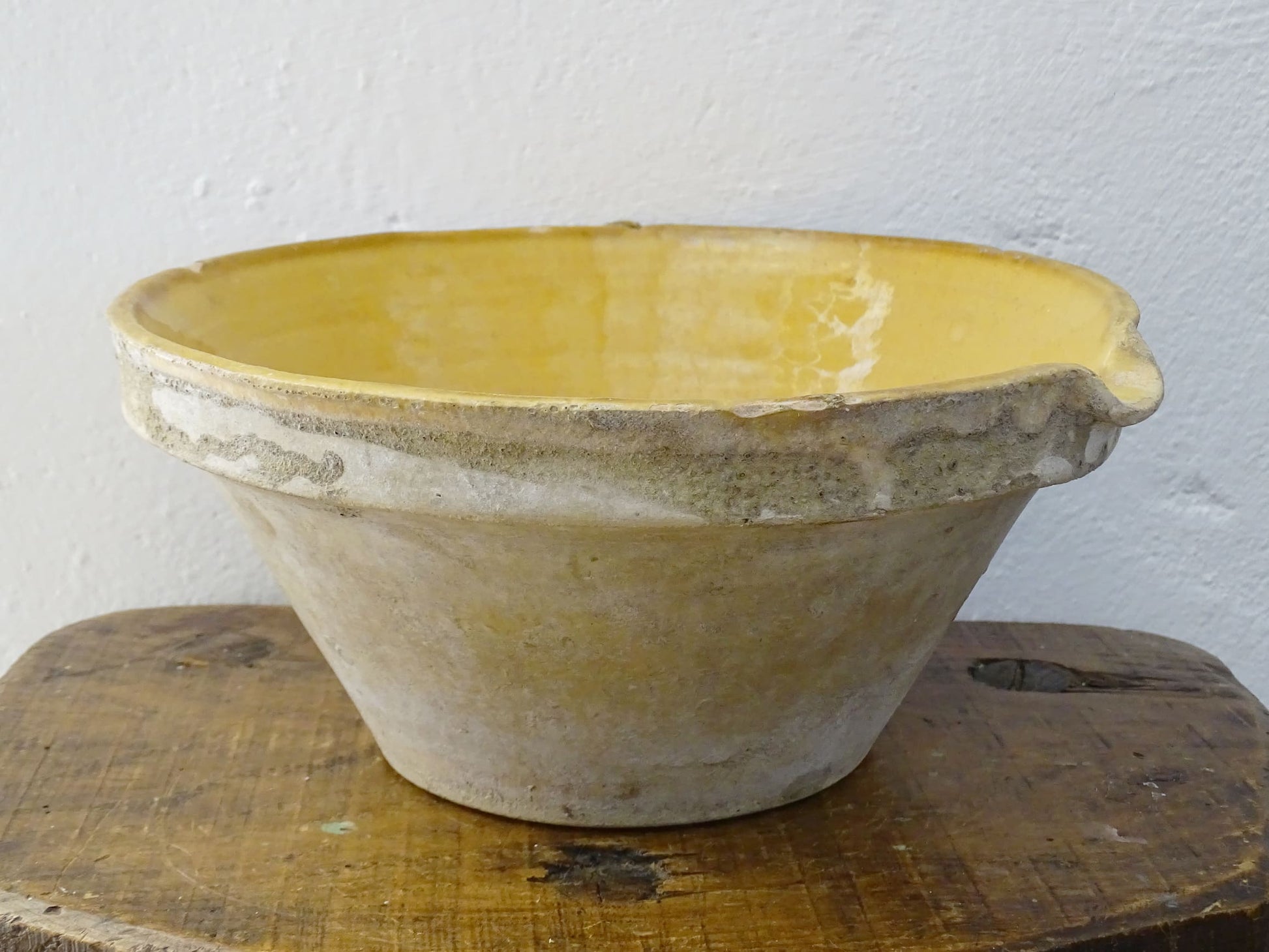 Antique French terracotta pottery tian or bowl with a yellow glaze to the interior. The earthenware gresale has no glaze to the outside and has a rustic appearance. 