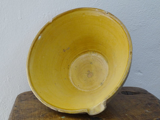 Antique French terracotta pottery tian or bowl with a yellow glaze to the interior. The earthenware gresale has no glaze to the outside and has a rustic appearance. 