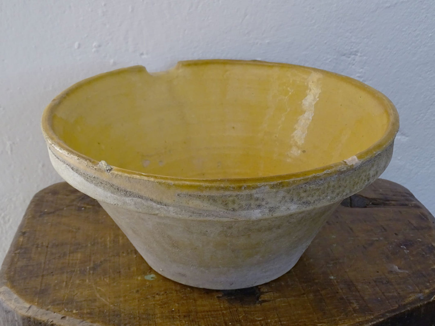 Antique French terracotta pottery tian or bowl with a yellow glaze to the interior. The earthenware gresale has no glaze to the outside and has a rustic appearance. 