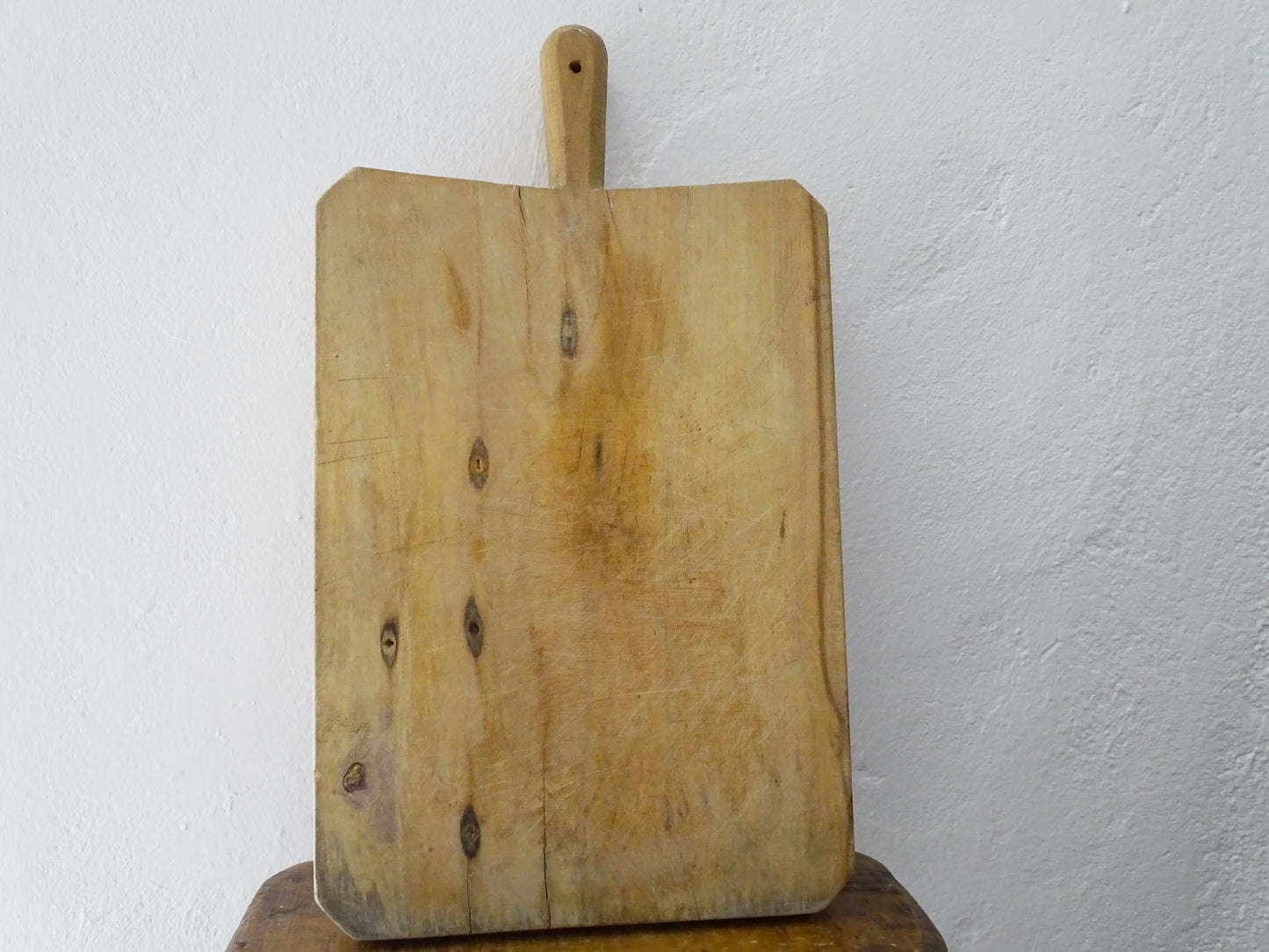 Vintage rustic French wooden cutting or chopping board, this vintage block with patina has a long handle.