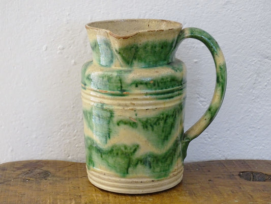 French antique ceramic Dieulefit jug or pitcher with cream background and green drip glaze and side spout. 
