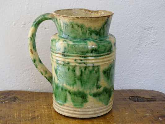 French antique ceramic Dieulefit jug or pitcher with cream background and green drip glaze and side spout.