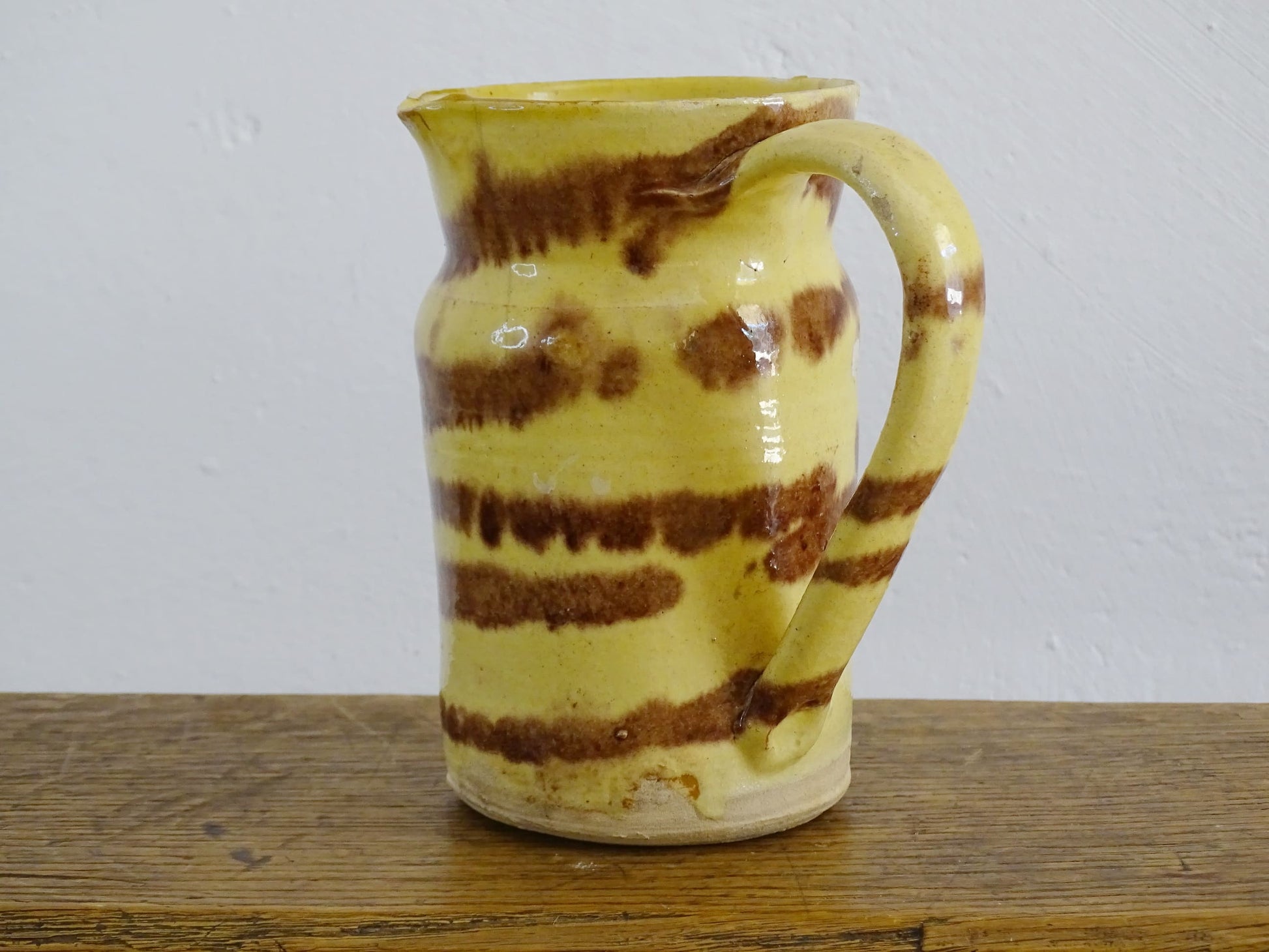 French antique ceramic jug from Dieulefit with a yellow glaze with brown drip glaze stripe.