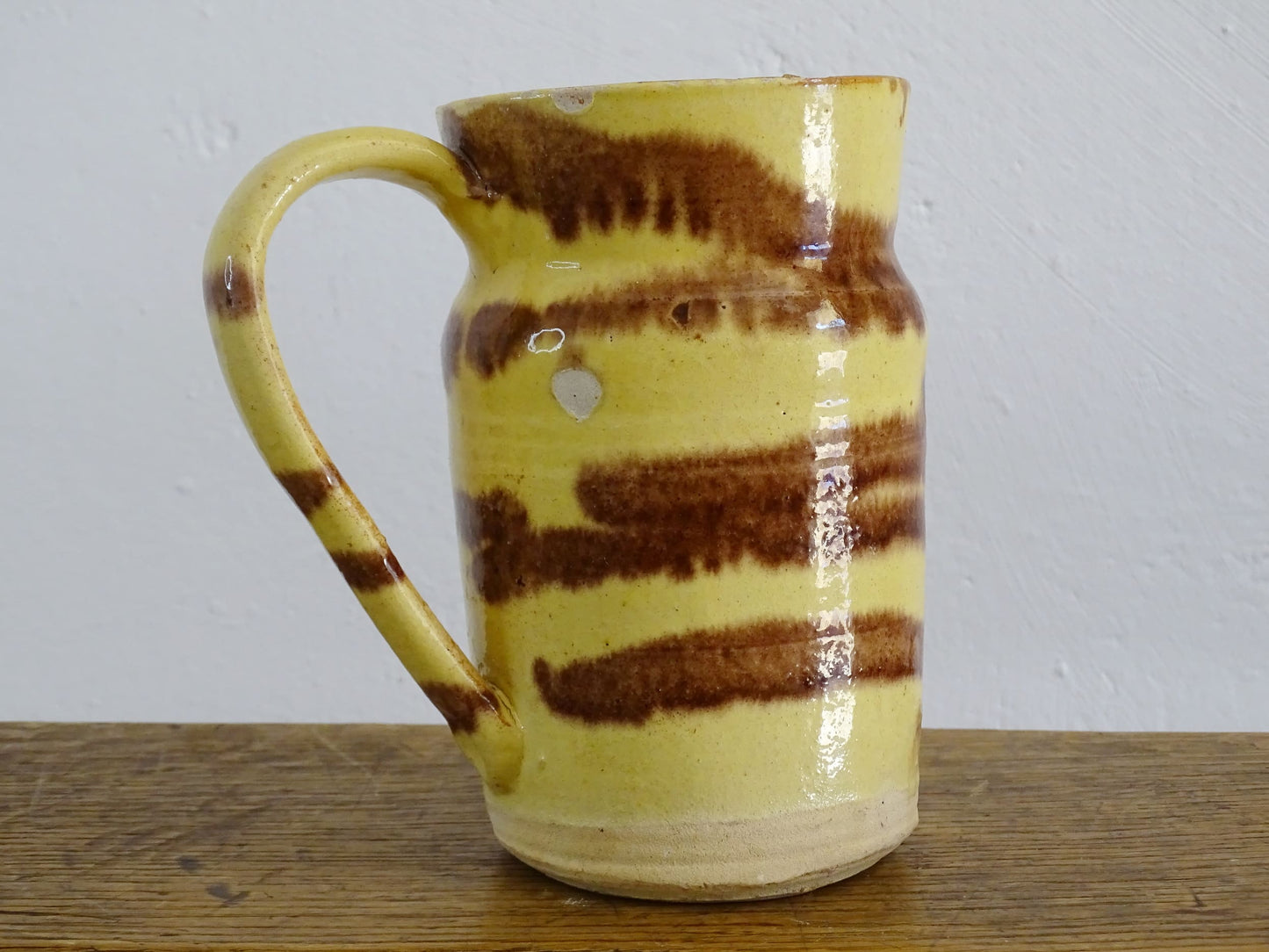 French antique ceramic jug from Dieulefit with a yellow glaze with brown drip glaze stripe.