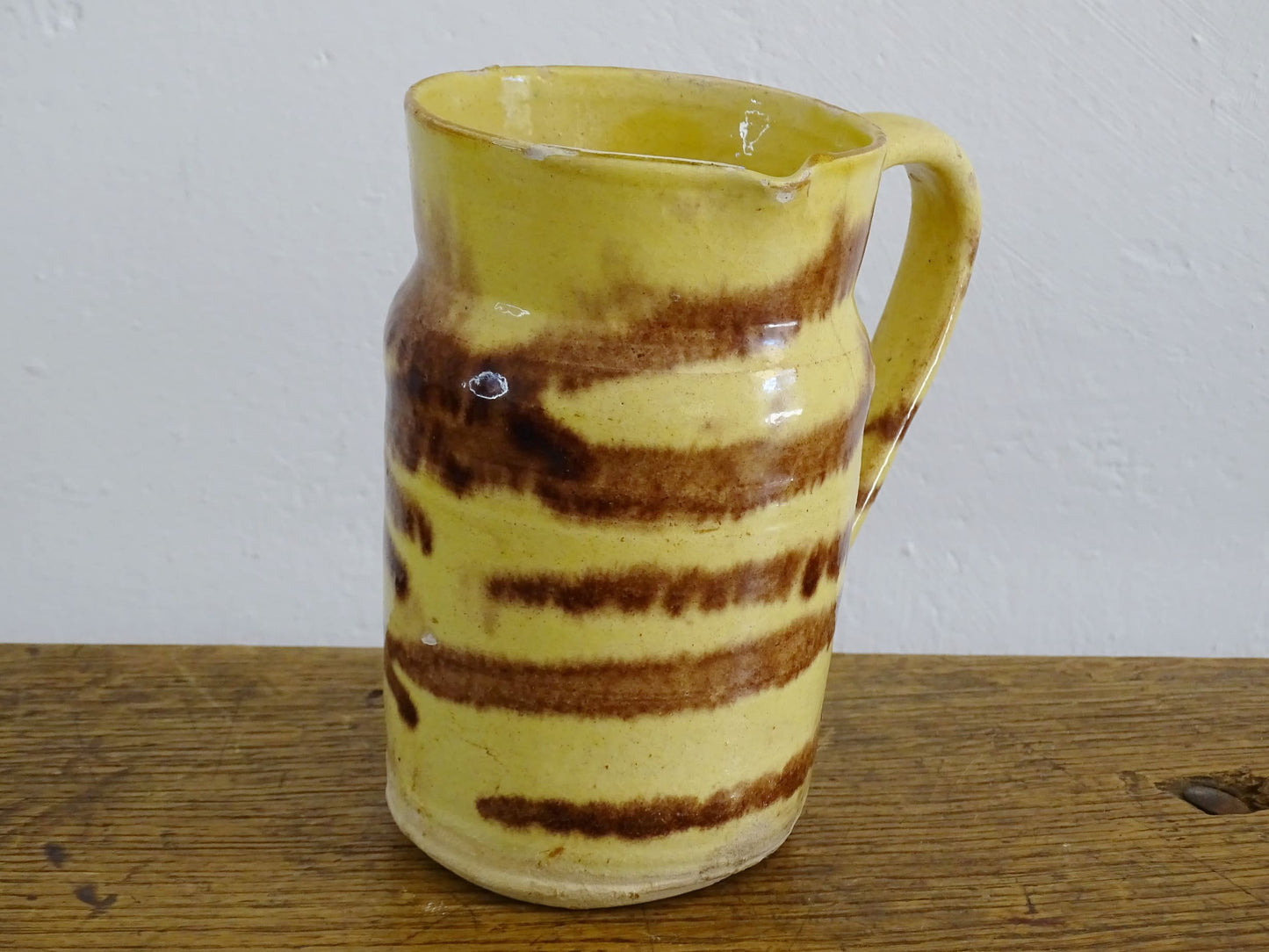 French antique ceramic jug from Dieulefit with a yellow glaze with brown drip glaze stripe.