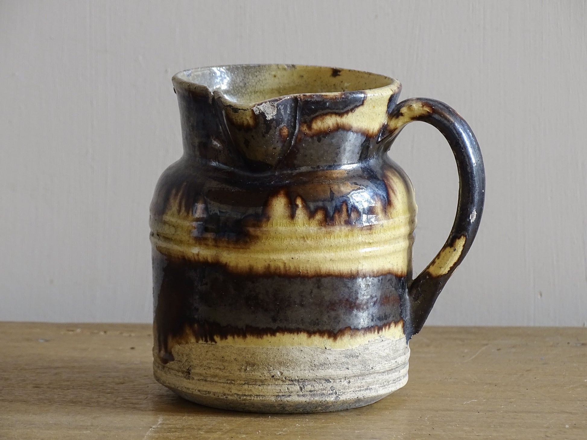 French antique ceramic pitcher with brown and yellow glaze