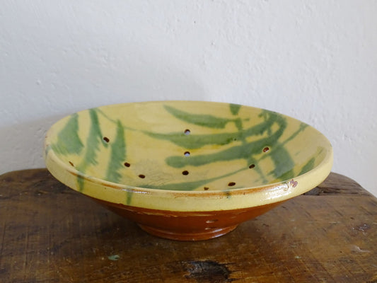 French antique ceramic colander with a yellow and green glaze. Pottery colander for berries. 