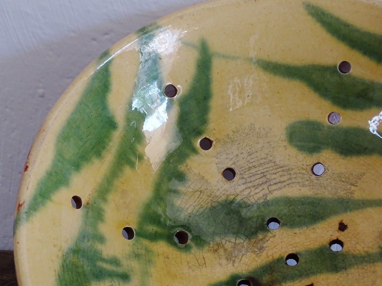 French antique ceramic colander with a yellow and green glaze. Pottery colander for berries. 