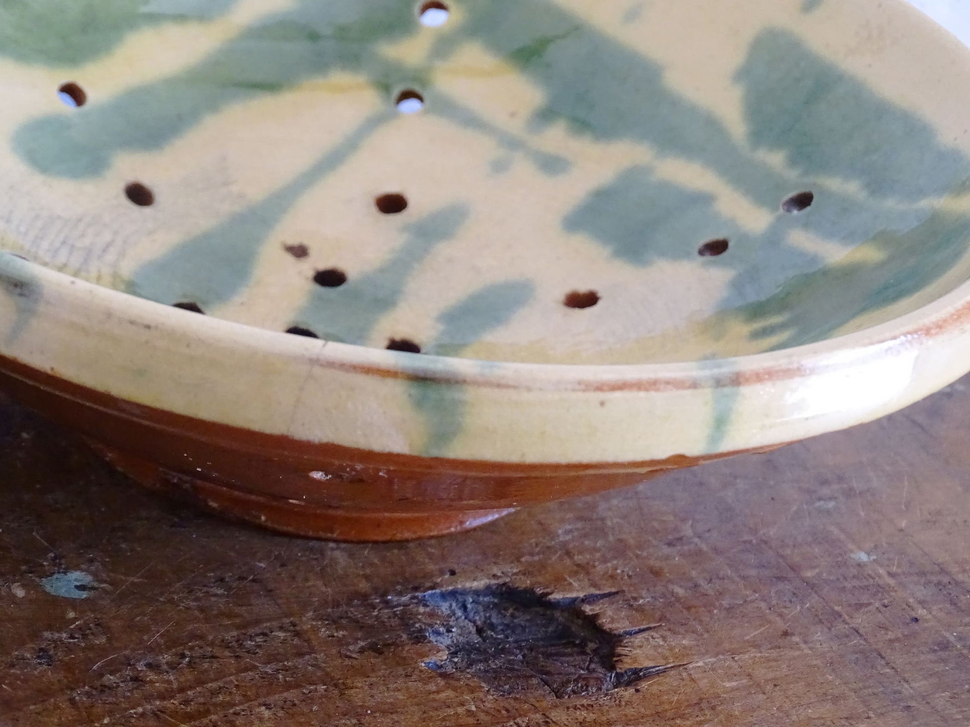 French antique ceramic colander with a yellow and green glaze. Pottery colander for berries. 