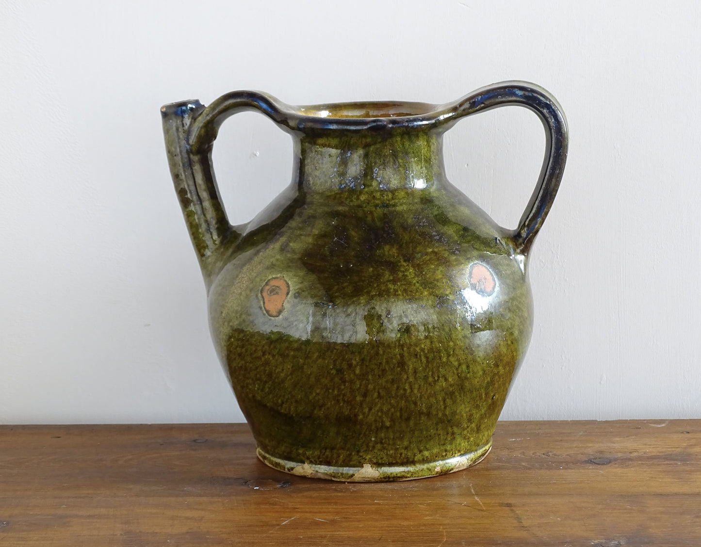 French antique cruche or orjol with an earthy green glaze. Antique terracotta water jug from the Languedoc with a timeworn appearance. French farmhouse aesthetic.