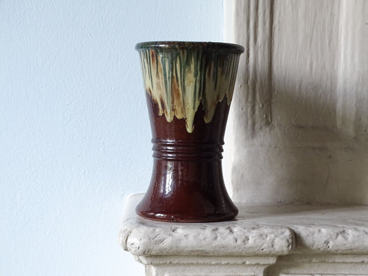 French antique ceramic vase with drip glaze, pictured on a country house fireplace