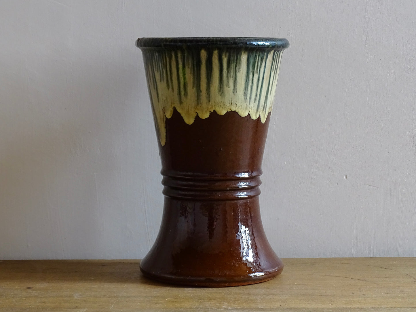 French antique glazed terracotta vase. Brown glazed pottery vase with drip glaze in cream and green.