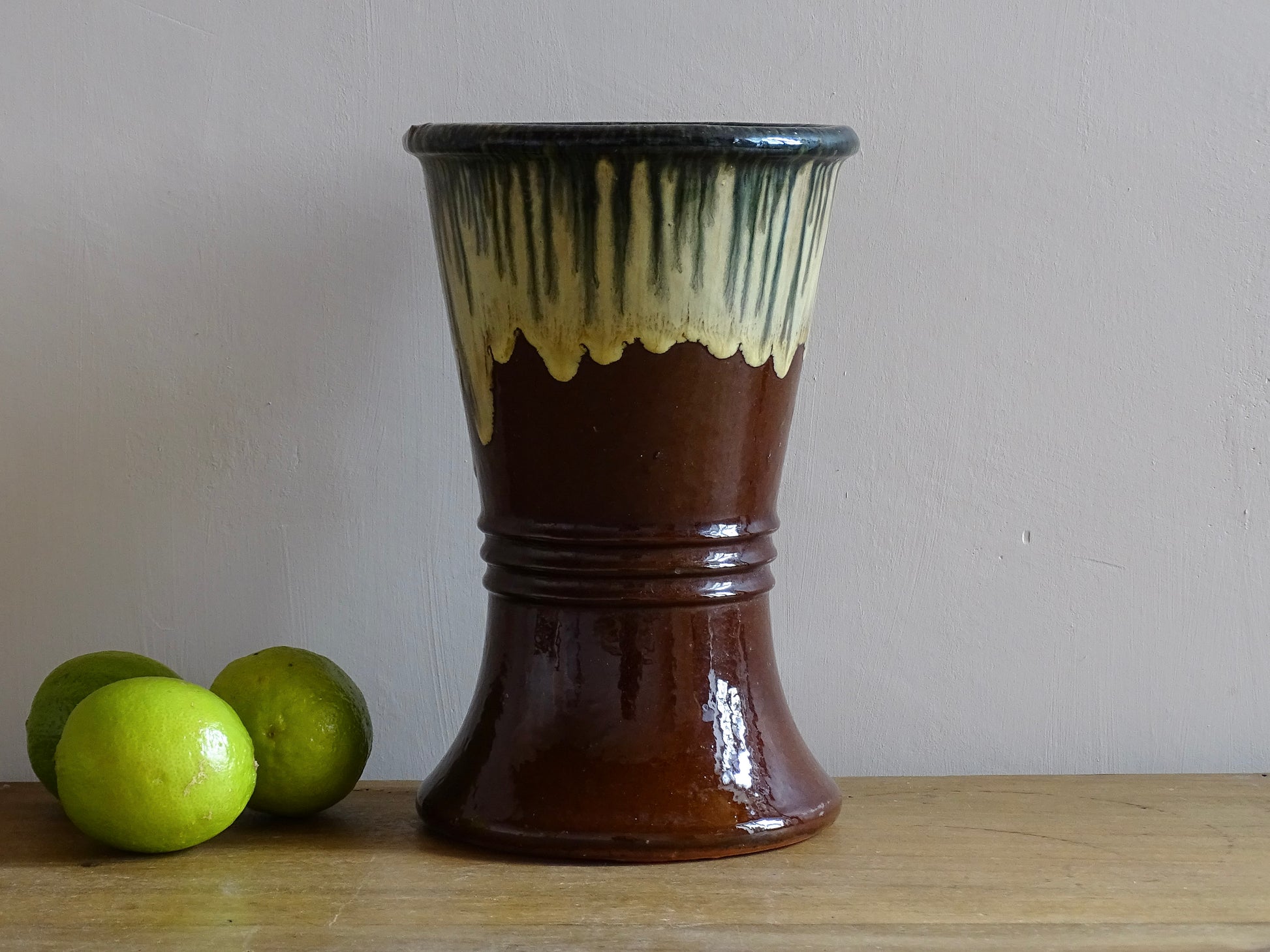 French antique glazed terracotta vase. Brown glazed pottery vase with drip glaze in cream and green.