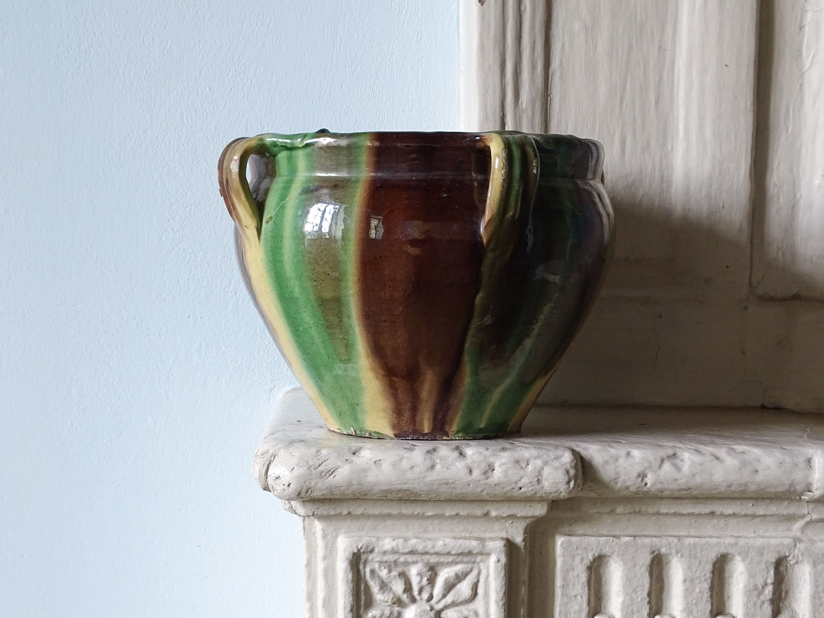 French antique ceramic planter or cache pot from Castelnaudary with a brown, green and yellow glaze, pictured on a country house fireplace