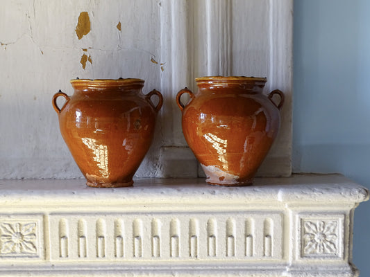 Pair of French antique ceramic confit vases with a red glaze exterior and yellow glaze interior