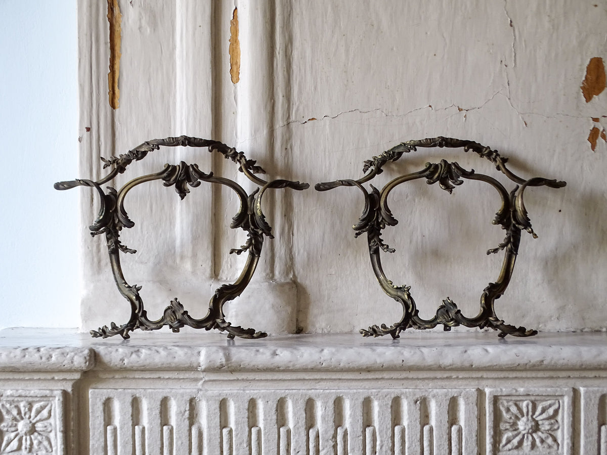French antique gilt bronze furniture pediments, displayed on a country house fireplace
