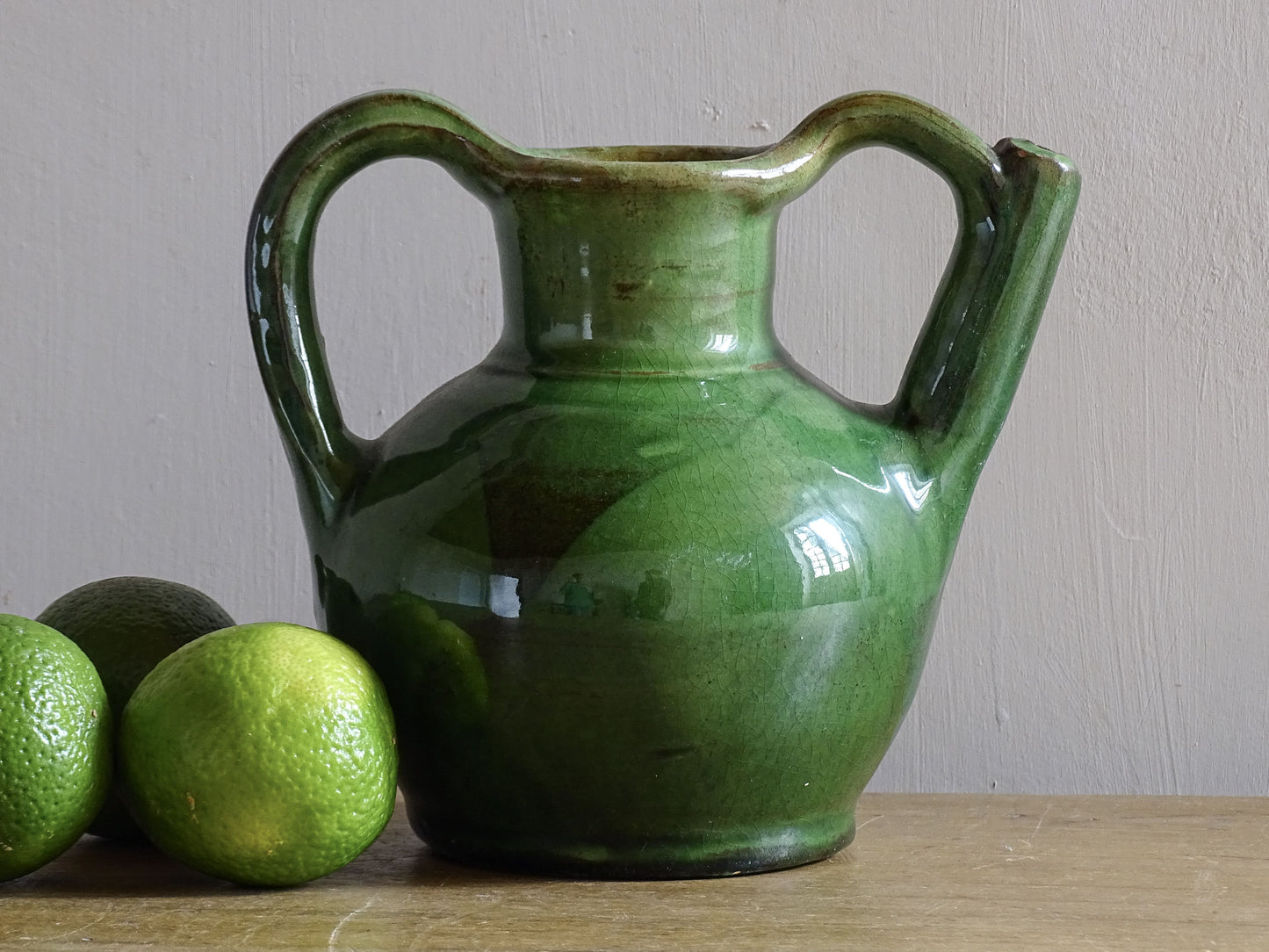 French vintage pottery pitcher or orjol with a green glaze. 