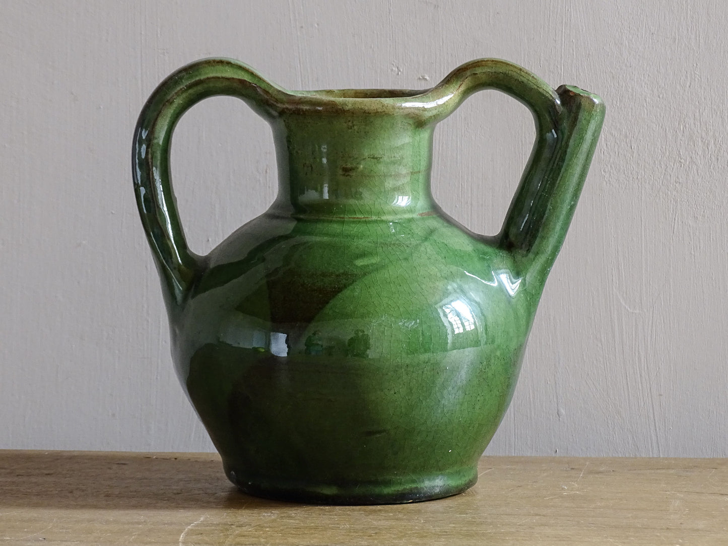 French green ceramic jug or orjol with handle and spout.