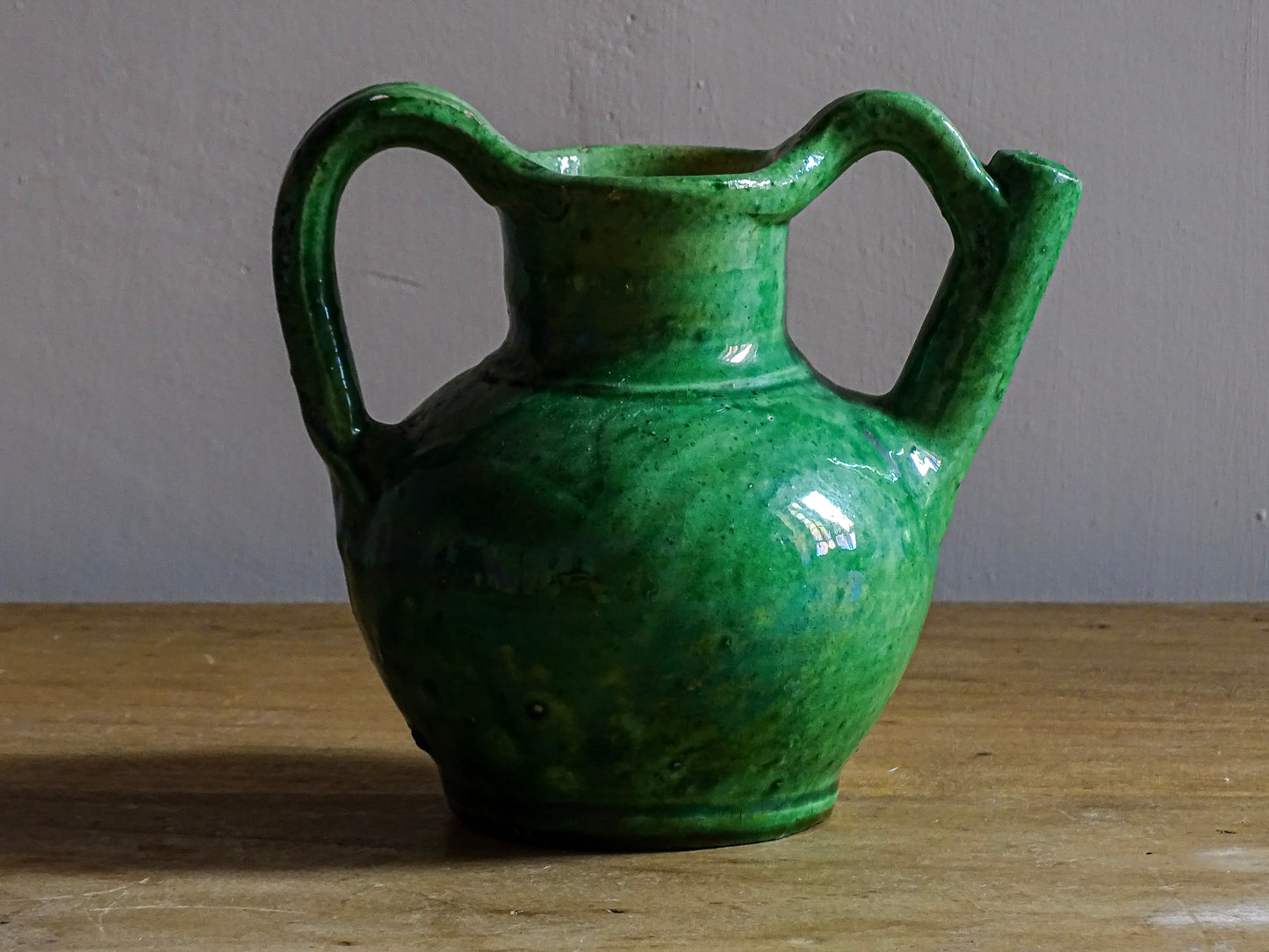 French antique green orjol or cruche in glazed terracotta. The green glaze of this pottery water jug has a pearlescent touch, with a yellow glaze to the interior.