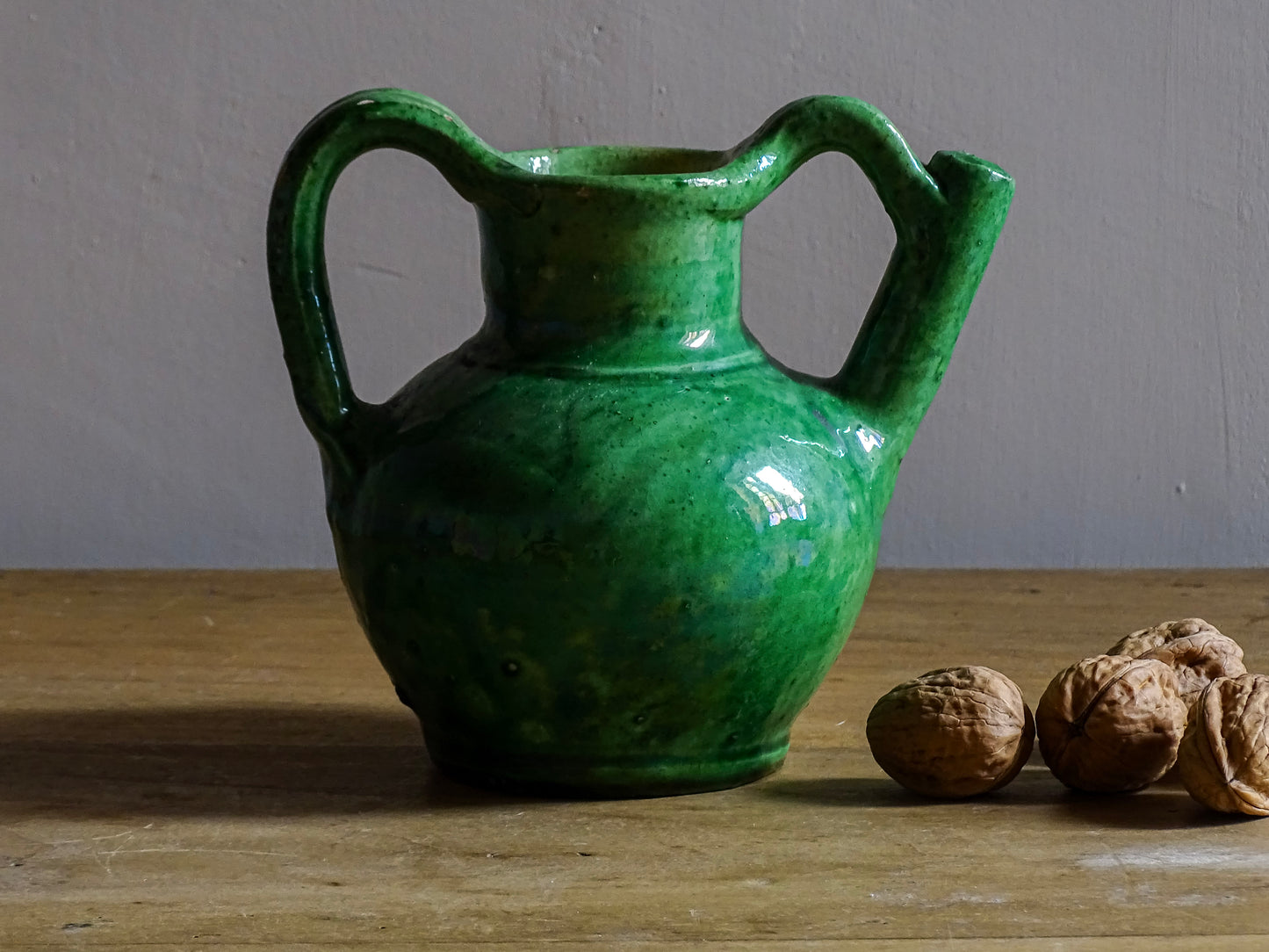 French antique green orjol or cruche in glazed terracotta. The green glaze of this pottery water jug has a pearlescent touch, with a yellow glaze to the interior.