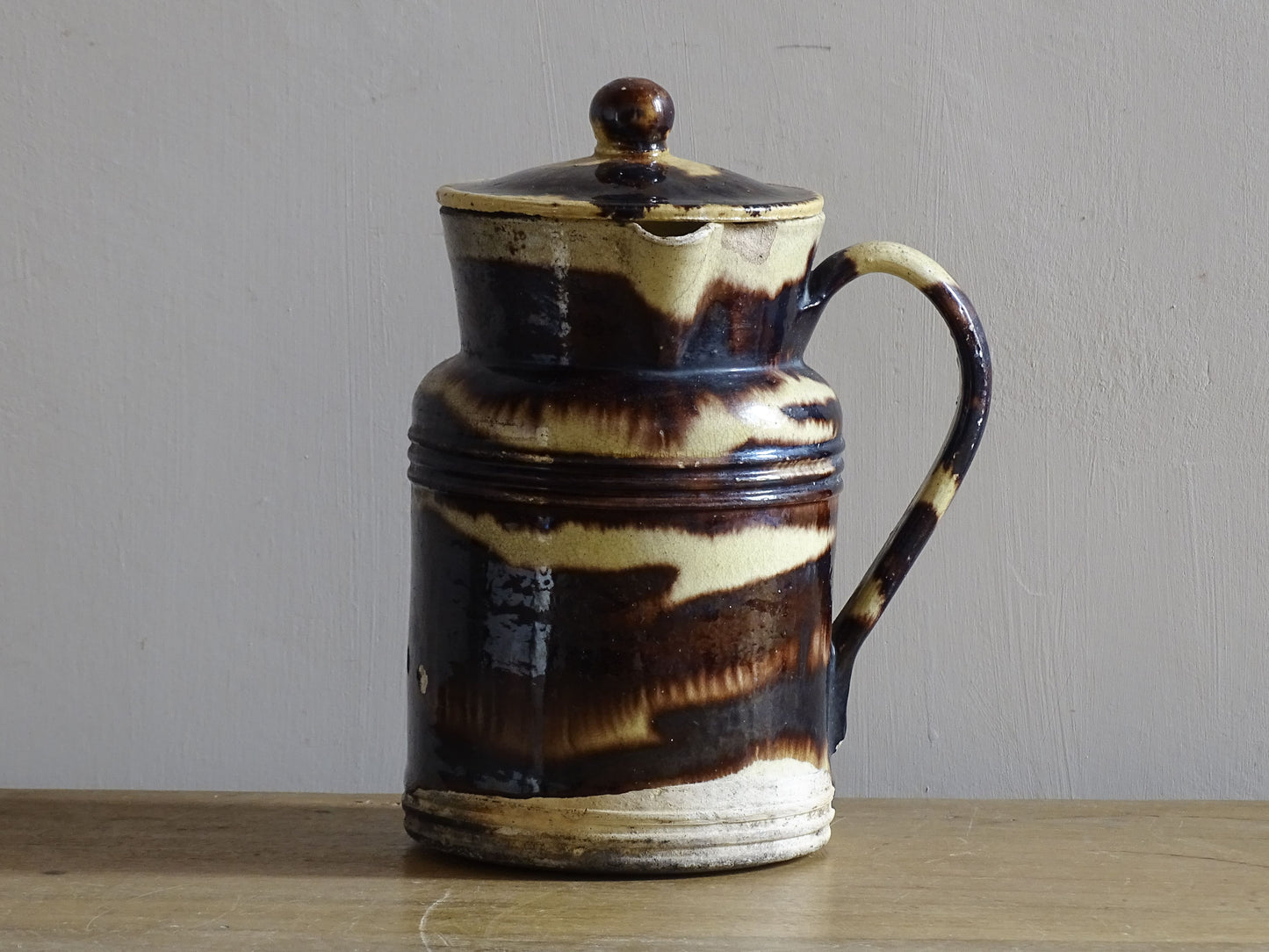 French antique ceramic pitcher with a lid and yellow and brown glaze with organic stripes. Dieulefit Pottery.