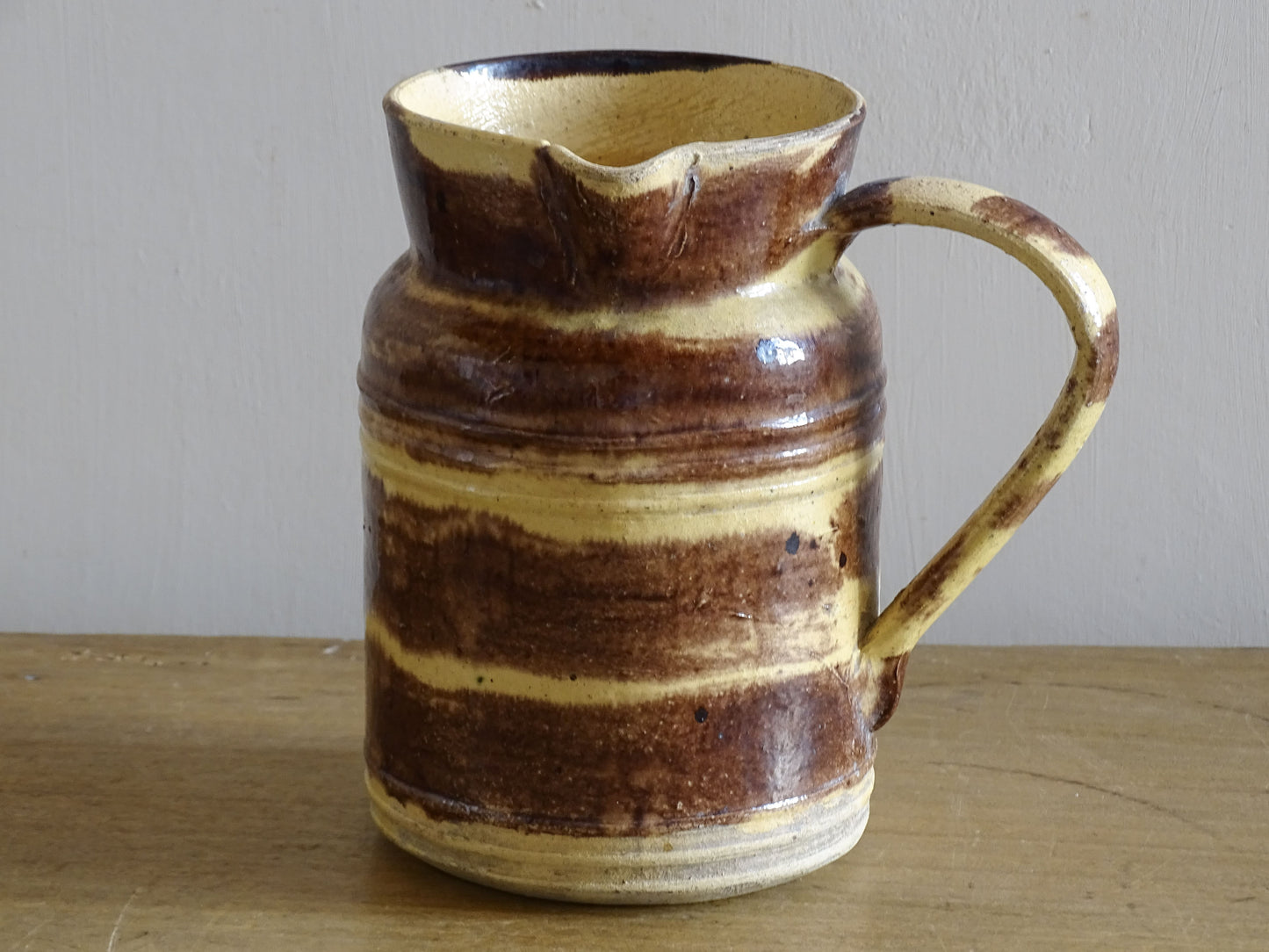French antique ceramic pitcher from Dieulefit with a brown and yellow glaze.