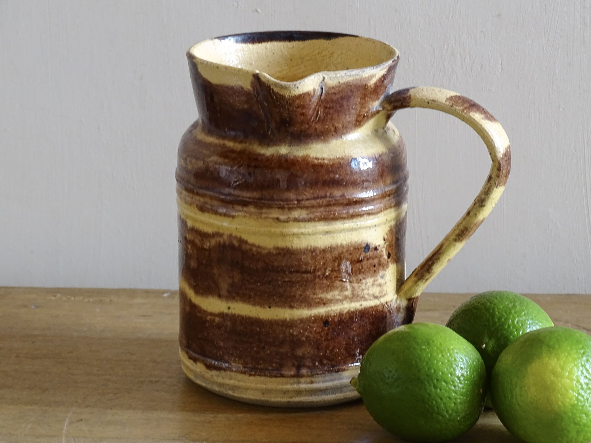 French antique ceramic pitcher from Dieulefit with a brown and yellow glaze.