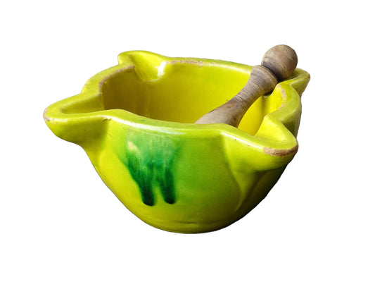French vintage ceramic pestle and mortar with a yellow glaze and green drip glaze detailing. Wooden pestle with patina.