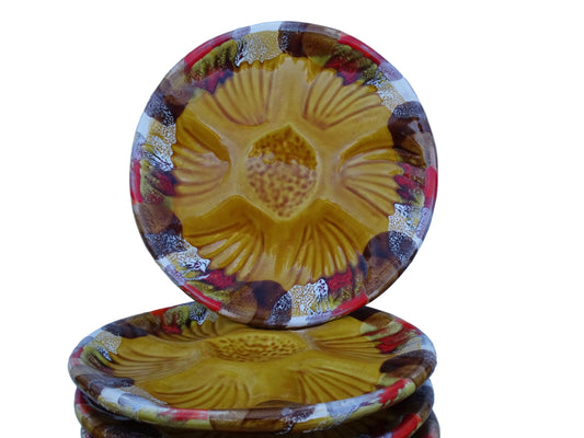 French vintage Vallauris pottery oyster plates with an ochre yellow glaze and a freeform edge in brown, red and white.
