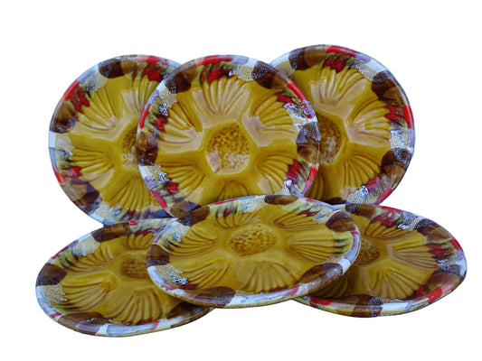 French vintage Vallauris pottery oyster plates with an ochre yellow glaze and a freeform edge in brown, red and white.