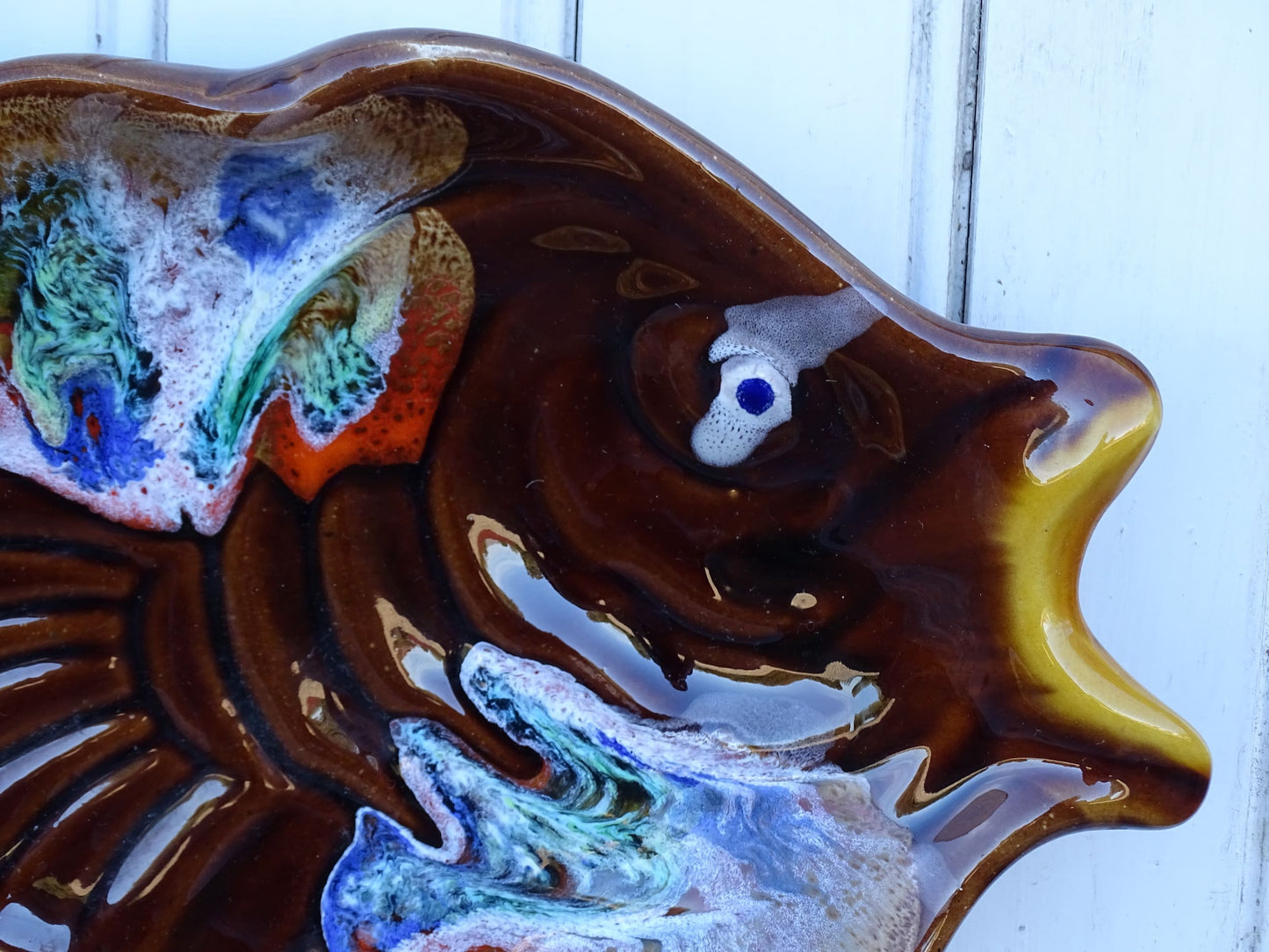 French vintage Vallauris pottery fish plate. It is glazed in brown with details in blue and red