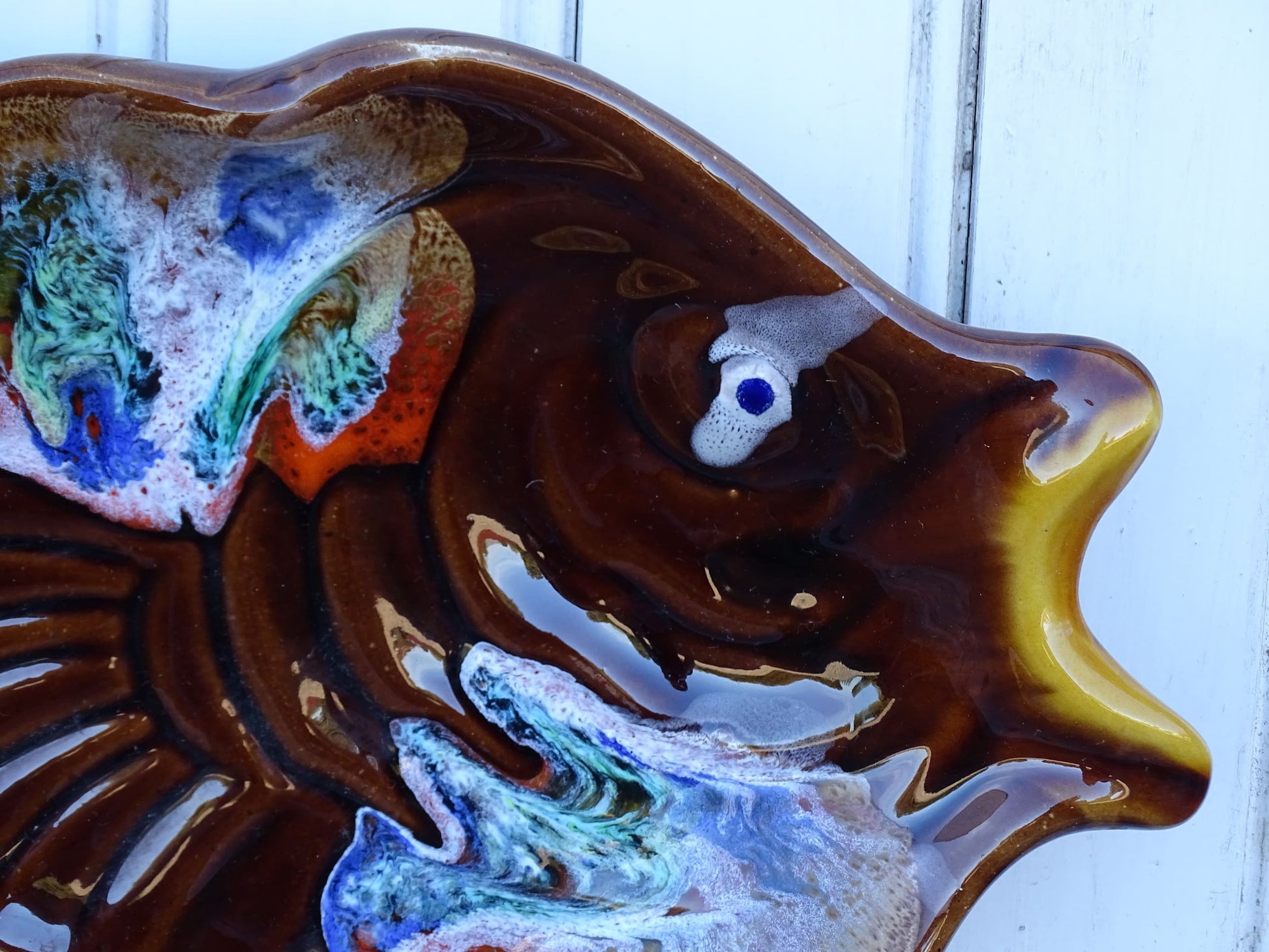 French vintage Vallauris pottery fish plate. It is glazed in brown with details in blue and red