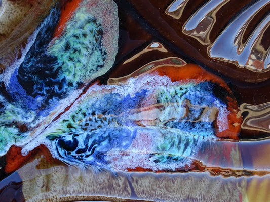 French vintage Vallauris pottery fish plate. It is glazed in brown with details in blue and red