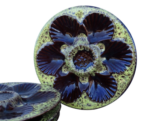 Set of four French vintage Vallauris ceramic oyster plates by Maruis Giuge with space for six oysters. They have a yellow and brown glaze.