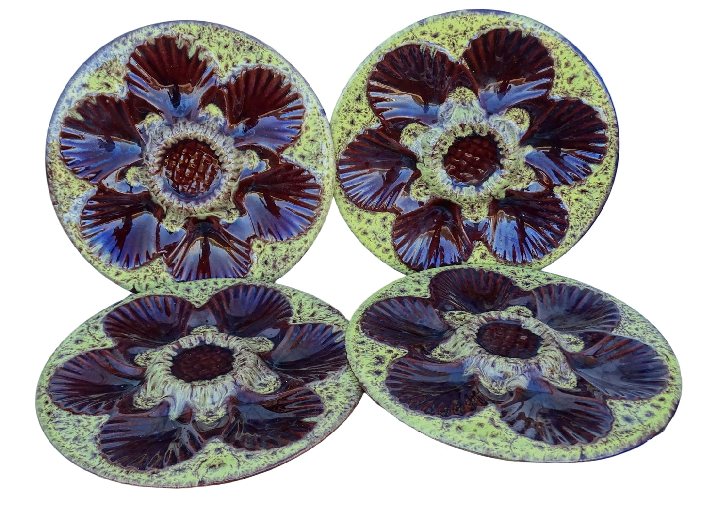 Set of four French vintage Vallauris ceramic oyster plates by Maruis Giuge with space for six oysters. They have a yellow and brown glaze.