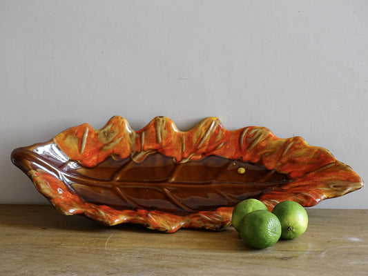 French vintage ceramic bowl in the shape of a leaf with red and orange glaze. Vallauris pottery