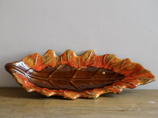 French vintage ceramic bowl in the shape of a leaf with red and orange glaze. Vallauris pottery