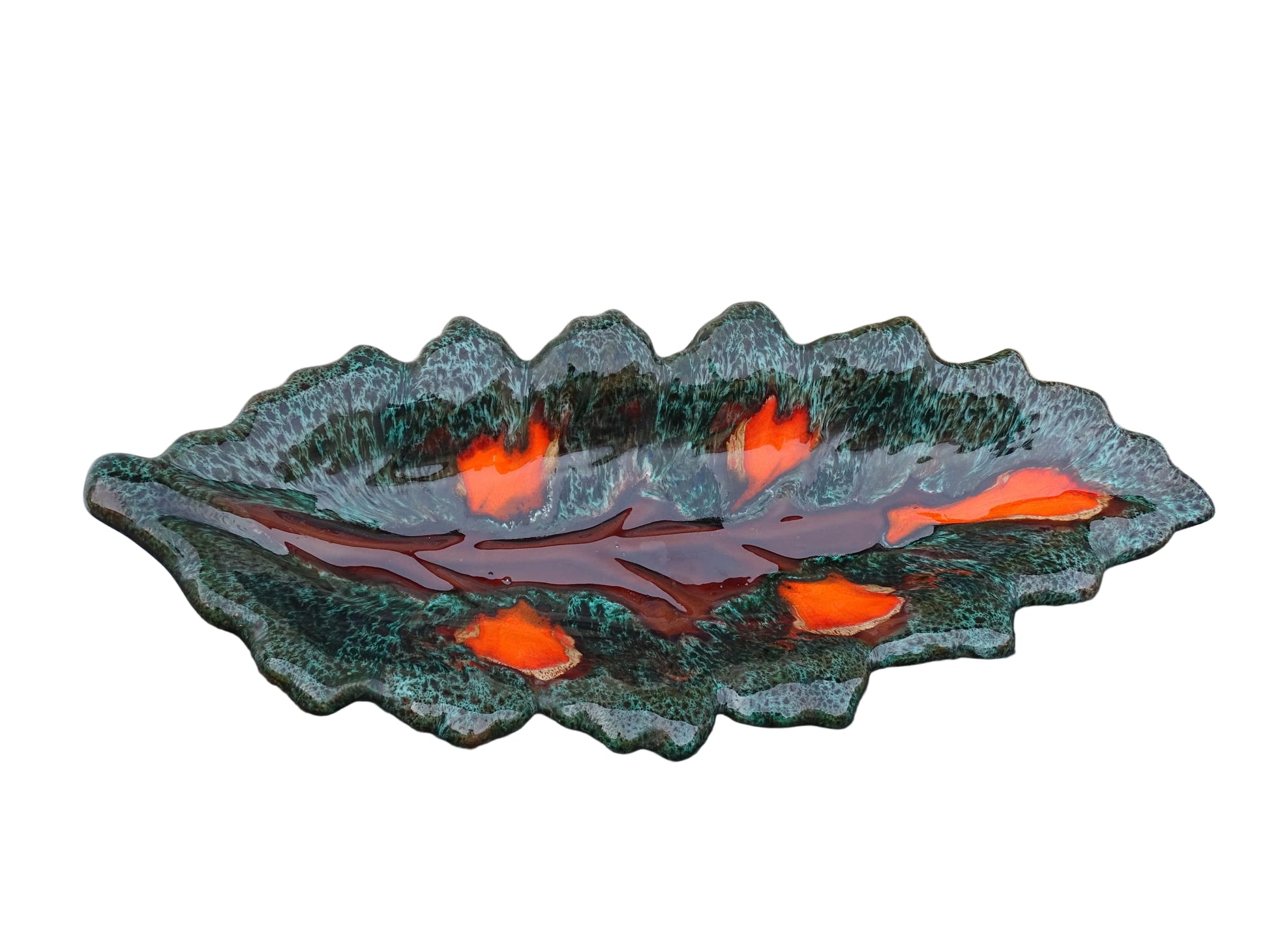 Large French vintage Vallauris ceramic bowl in the shape of a leaf. It is glazed with a dark green with details in brown and orange.