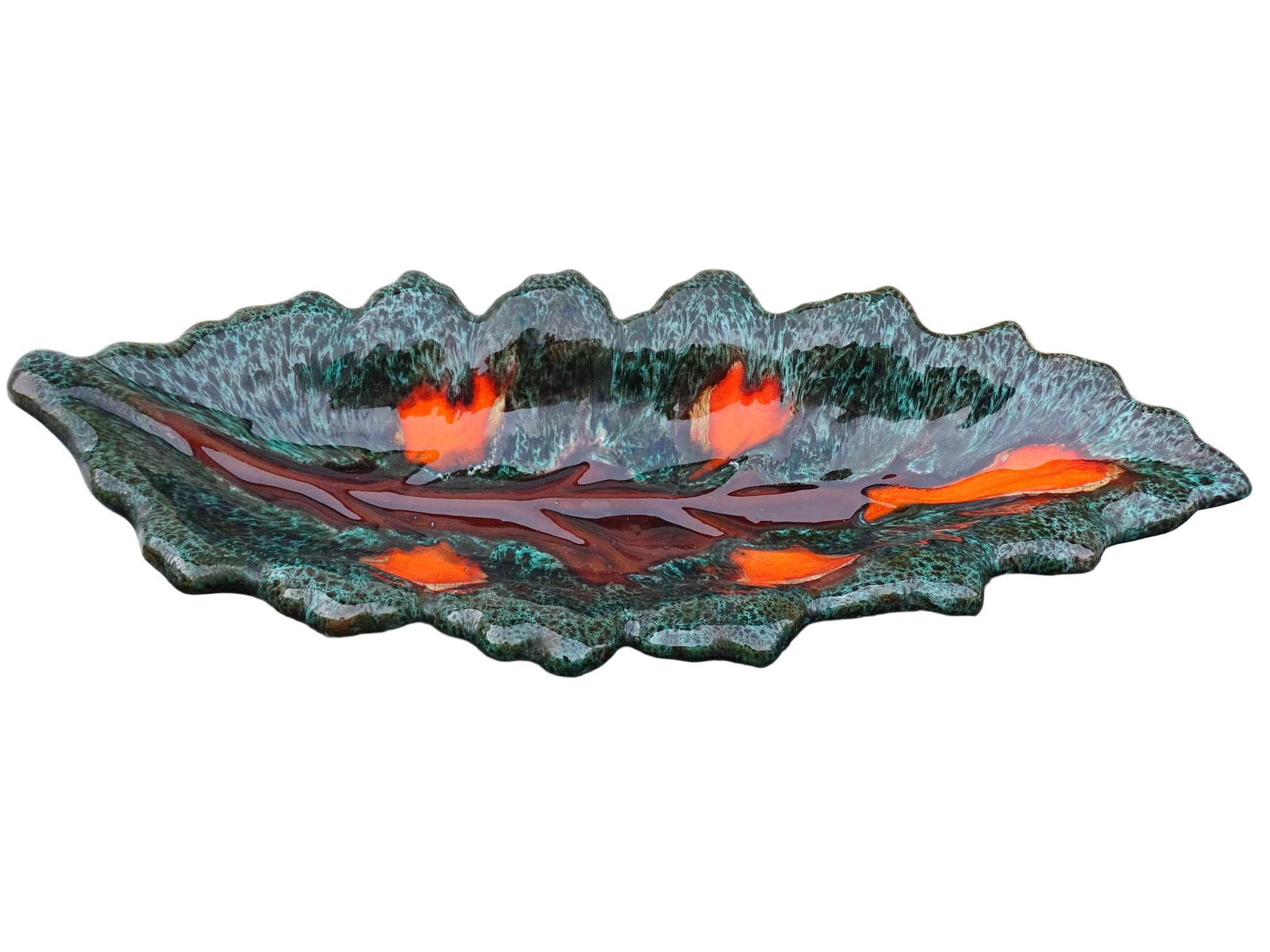 Large French vintage Vallauris ceramic bowl in the shape of a leaf. It is glazed with a dark green with details in brown and orange.