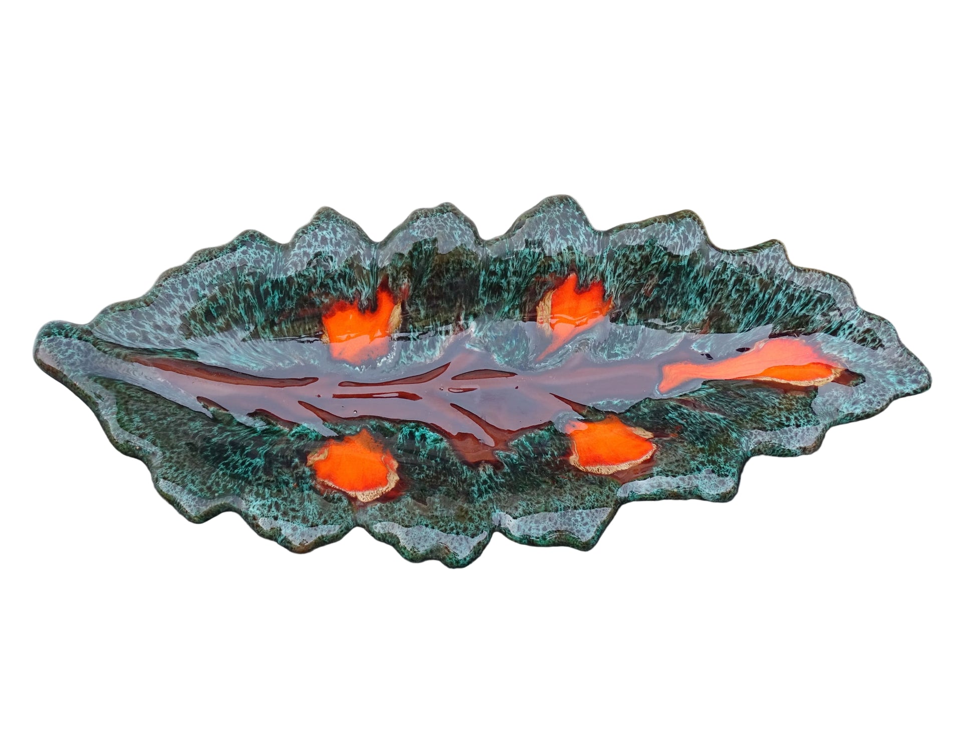 Large French vintage Vallauris ceramic bowl in the shape of a leaf. It is glazed with a dark green with details in brown and orange.