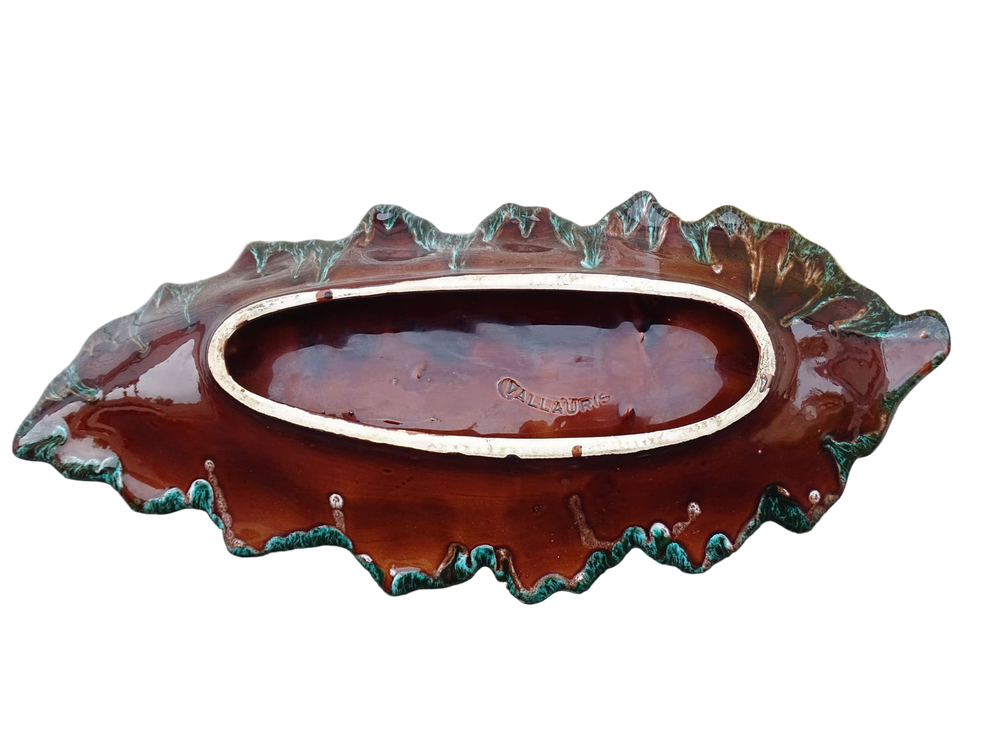 Large French vintage Vallauris ceramic bowl in the shape of a leaf. It is glazed with a dark green with details in brown and orange.