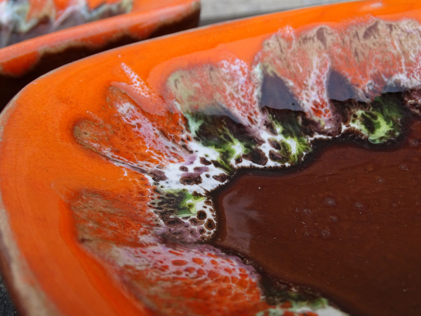 Pair of French vintage Vallauris ceramic dishes. Kidney shaped bowls with orange glaze with mid-century design.