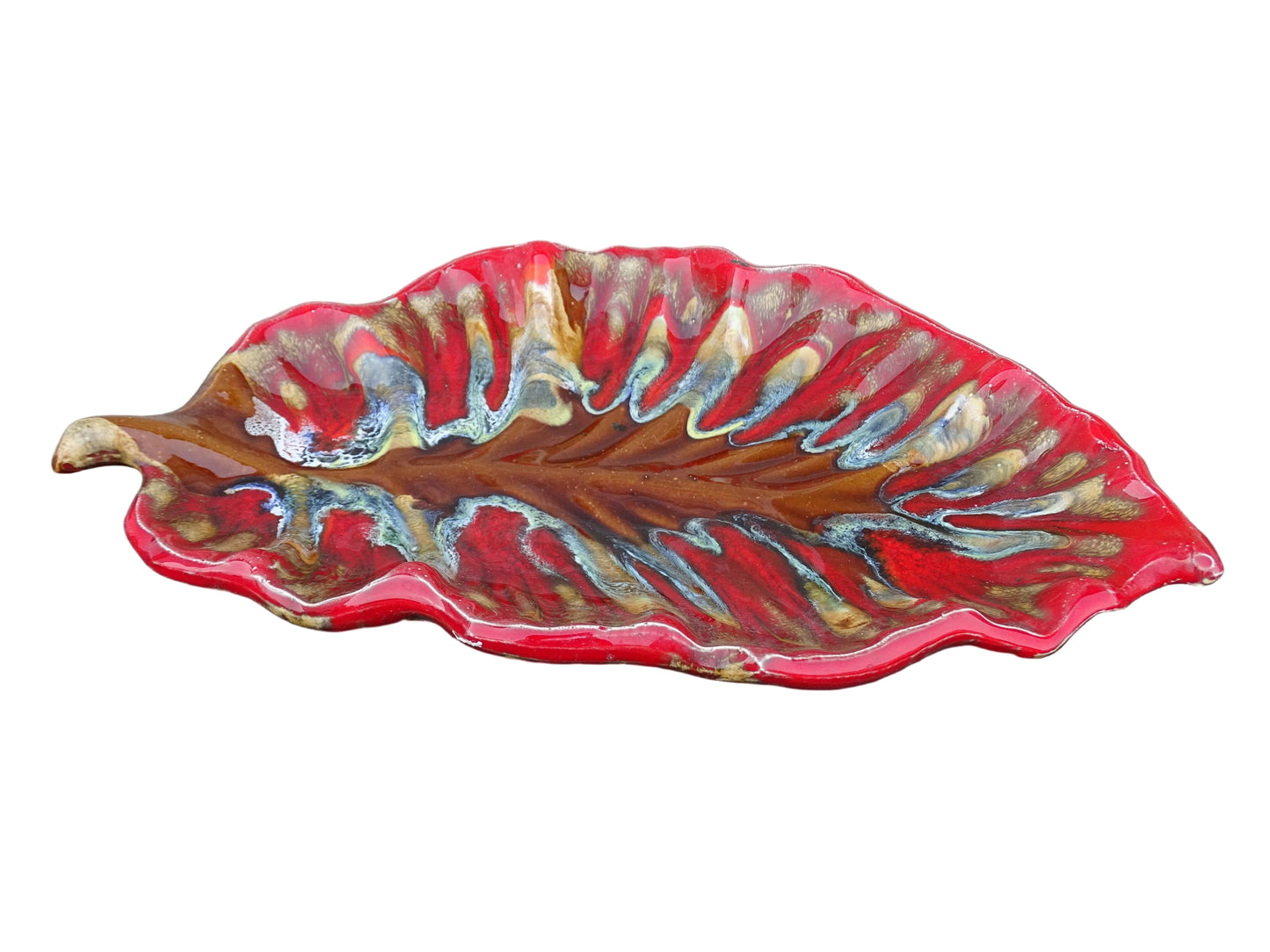 French vintage Vallauris ceramic dish in a leaf design. The pottery dish is glazed in red with details in pale blue, yellow and brown