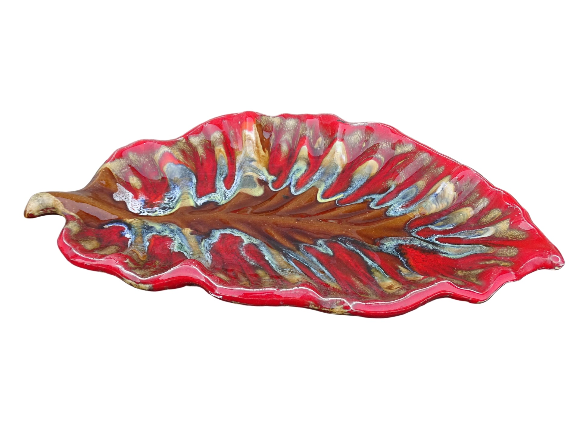 French vintage Vallauris ceramic dish in a leaf design. The pottery dish is glazed in red with details in pale blue, yellow and brown