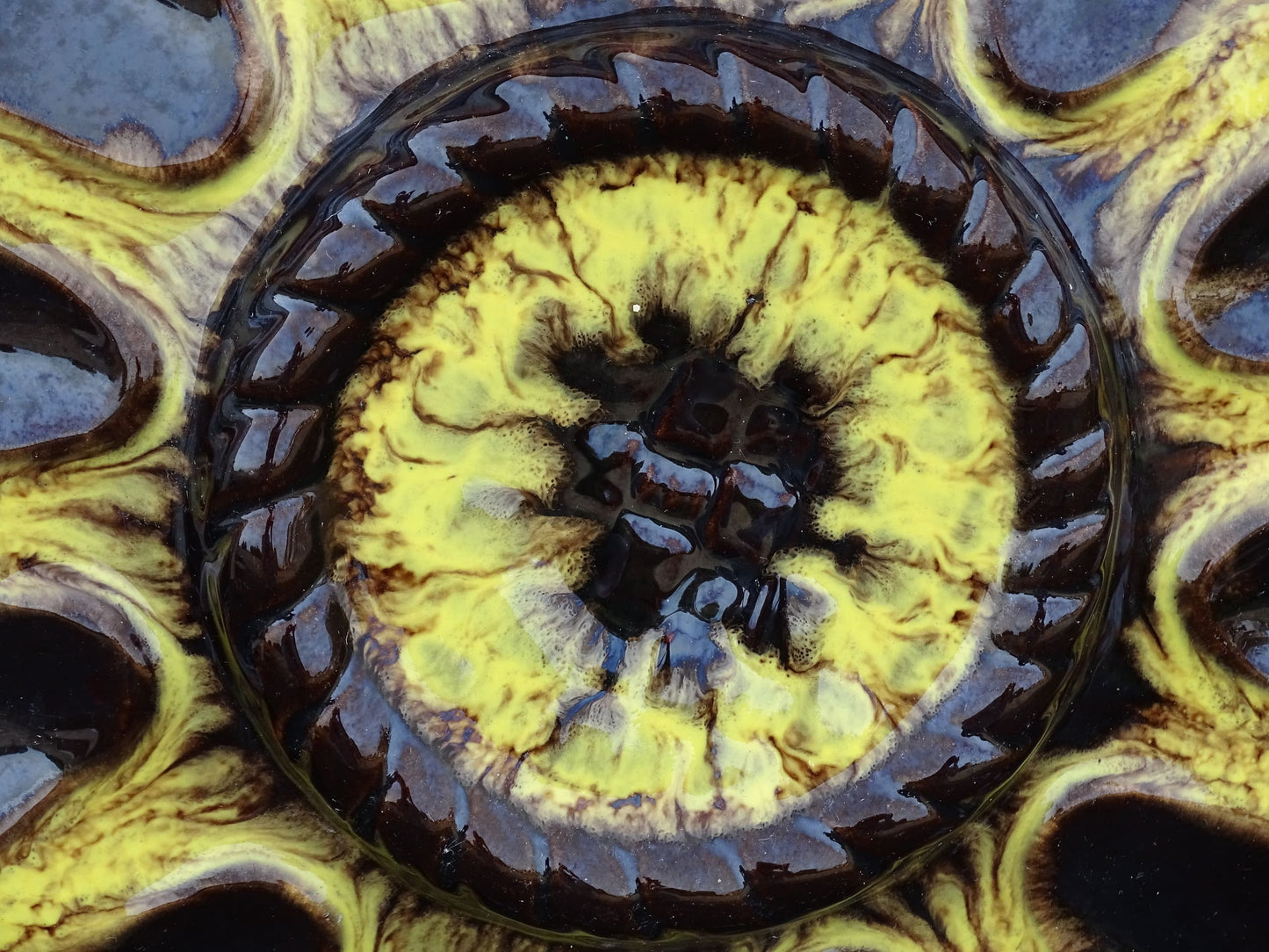 Large French vintage Vallauris pottery oyster plate by Maruis Giuge with space for twelve oysters. It has a yellow and brown glaze.